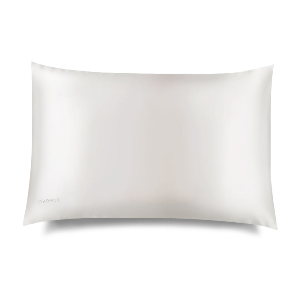 The Akoya Pearl Silk Pillowcase by us.drowsysleepco, renowned for its skincare and hair benefits, is displayed on a plain white background with soft shadows and the brand name printed in small text at the bottom left corner.