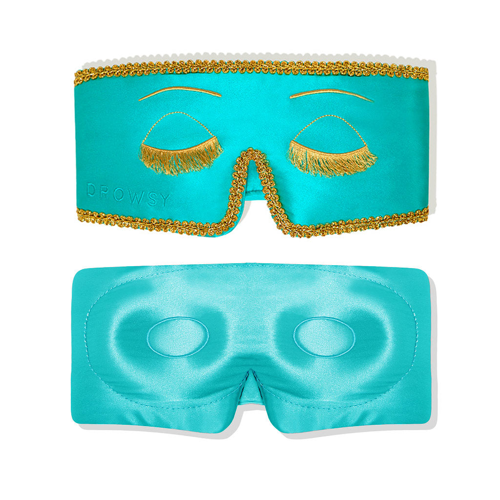 The Breakfast at Drowsy Eyelash Protecting Mask by drowsysleepco is a turquoise satin sleep mask with gold trim, embroidered closed eyes, and built-in eye cushions for comfort. Shown from the front and back.
