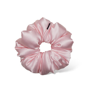 The Petal Pink Padded Scrunchie by us.drowsysleepco is an oversized, shiny satin hair accessory in light pink, displayed on a white background. Its smooth gathered design ensures comfort and supports hair health.