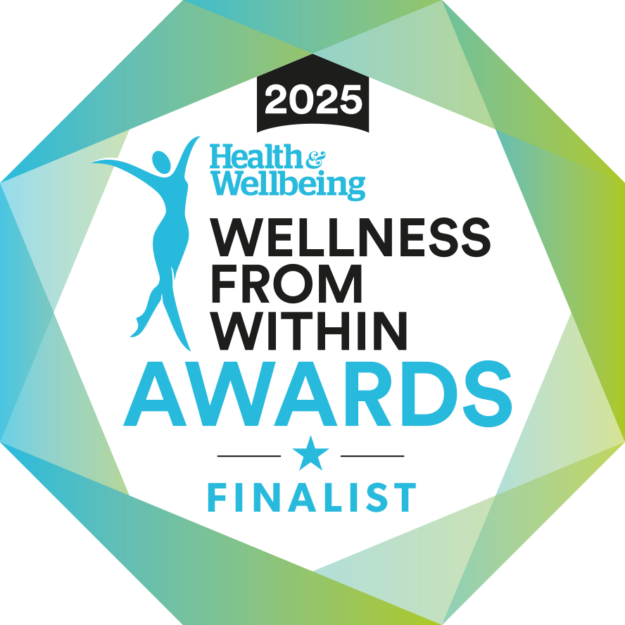 Hexagonal badge with text “2025 Health & Wellbeing Wellness From Within Awards Finalist,” featuring a blue silhouette of a person with arms raised, on a white center with a blue and green geometric border.