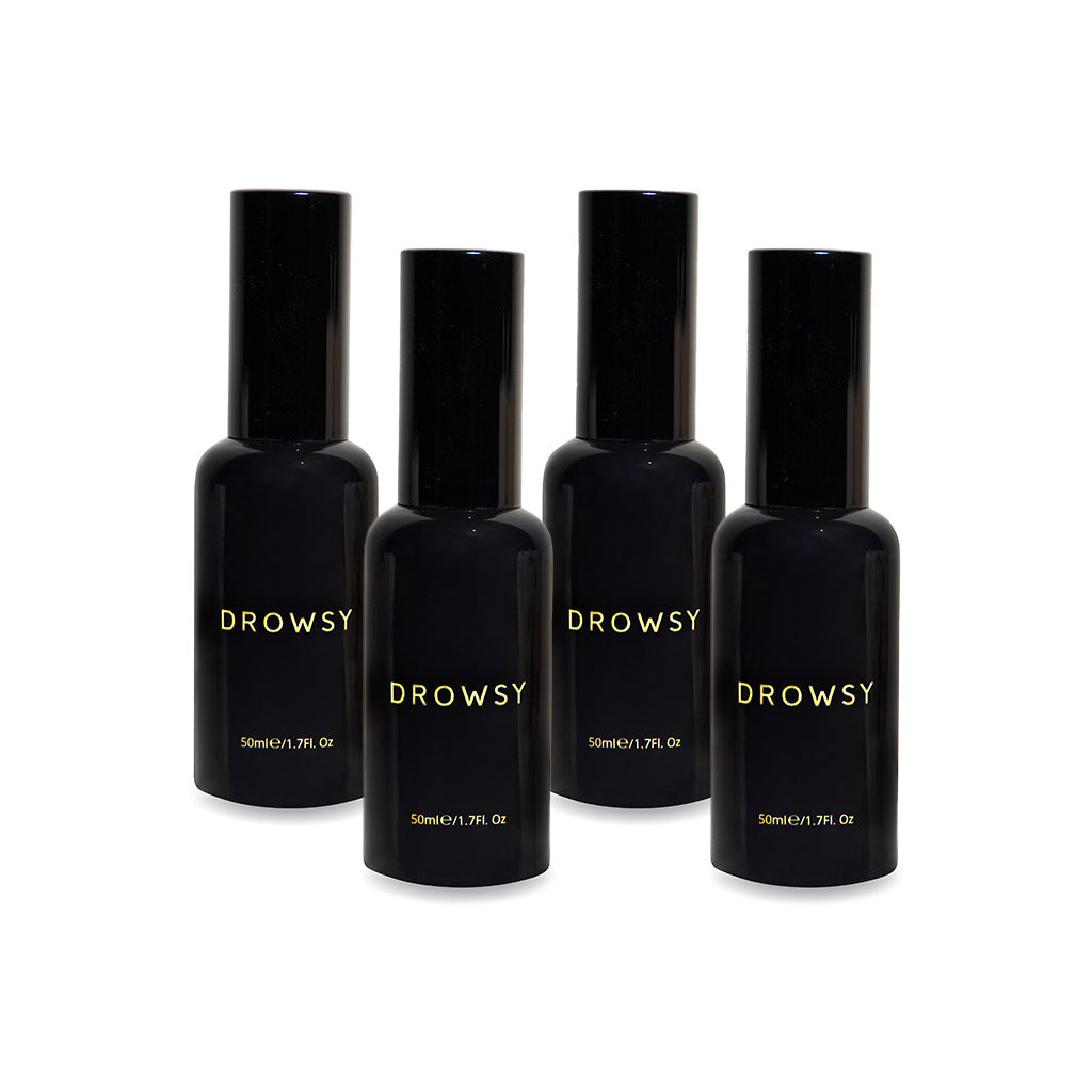 Four black Sleep S.O.S Pillow Spray bottles by us.drowsysleepco, with gold "DROWSY" text and 50ml/1.7 fl. oz below, upright on a white background—ideal for your night routine or as a natural sleep aid.