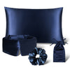 Explore the Sensual Sleep Bundle - Midnight Blue by drowsysleepco: a dark blue satin set featuring a pillowcase, sleep mask, scrunchie, and drawstring pouch, all elegantly shown against a white backdrop.