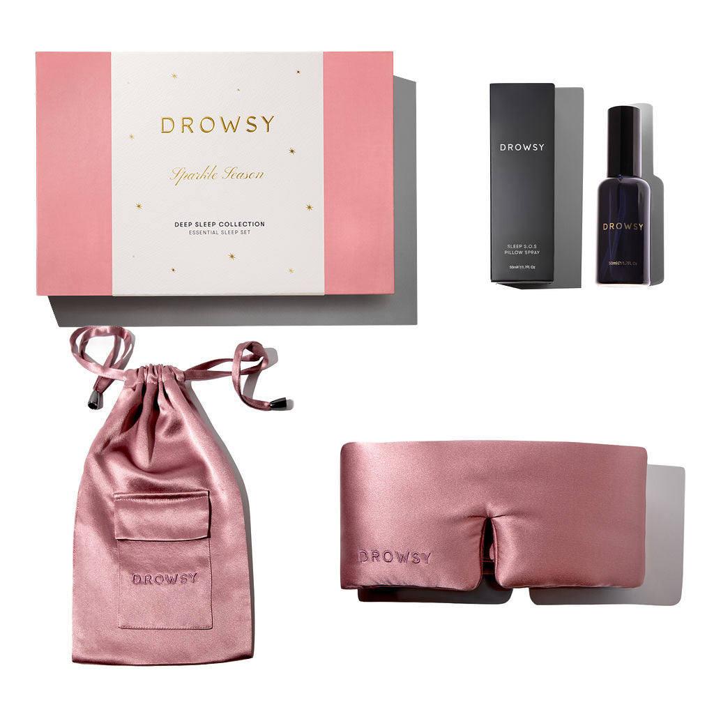 The Damask Rose - Deep Sleep Collection by us.drowsysleepco includes a luxury pink silk sleep mask, matching pouch, deep sleep pillow spray, and a pink and white gift box—your ultimate sleep essentials displayed on a white background.