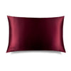 The La Vie En Rouge Silk Pillowcase by us.drowsysleepco is a rectangular burgundy silk case with a smooth, shiny finish and a subtle embroidered logo in the bottom left corner, displayed against a white background. Perfect for protecting hair.