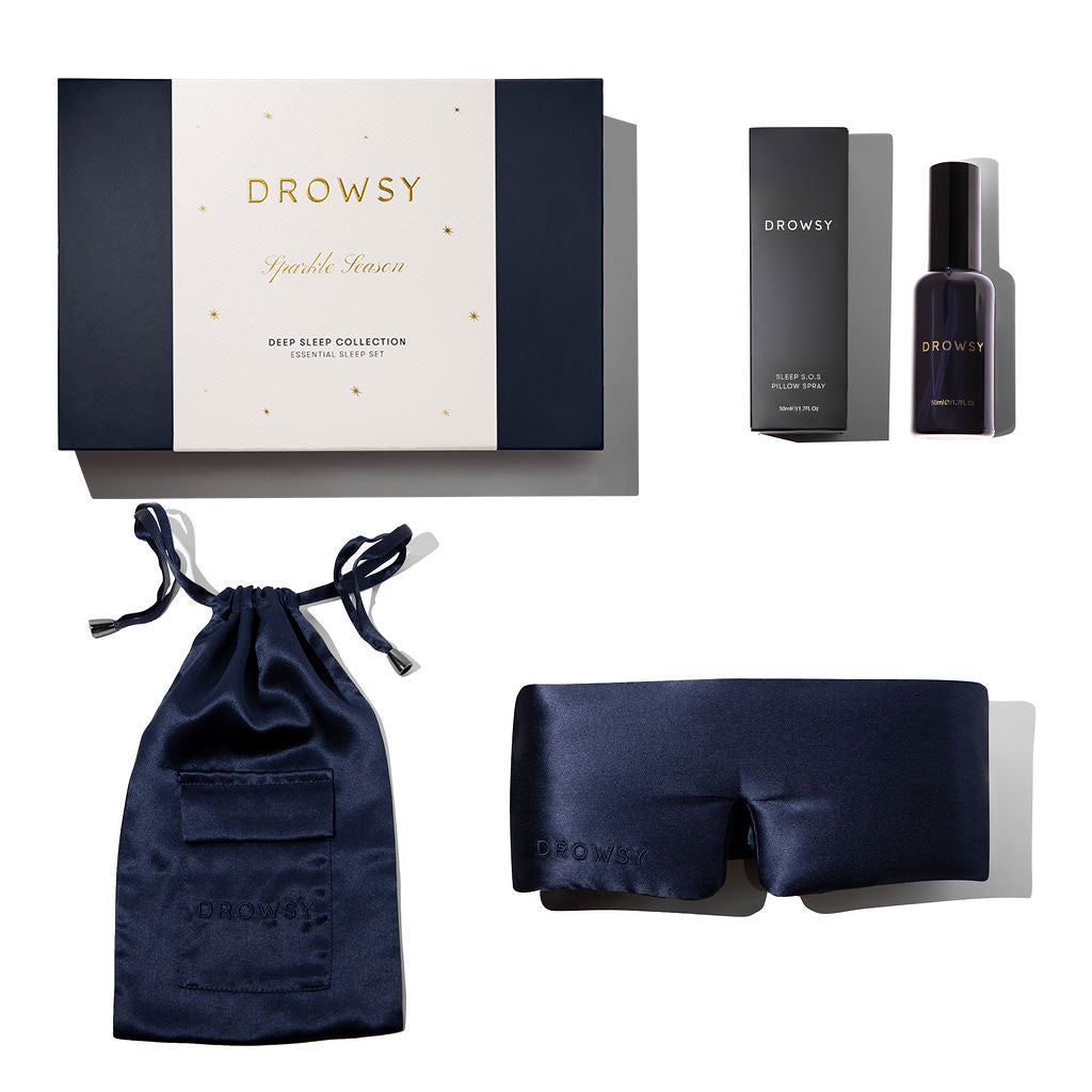 The us.drowsysleepco Midnight Blue - Deep Sleep Collection includes a luxury silk sleep mask, matching carry pouch, deep sleep pillow spray, and comes in a navy and white gift box.