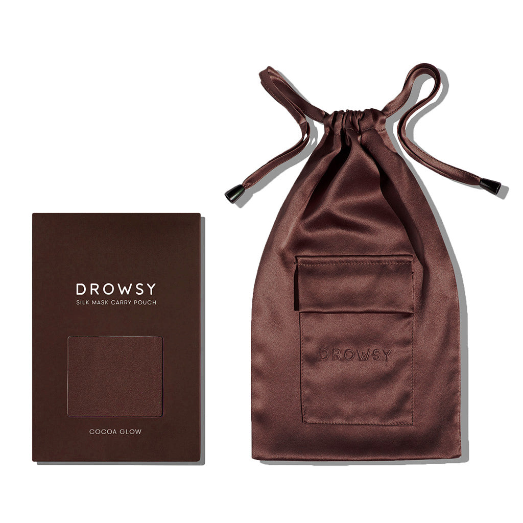 A brown drowsysleepco Cocoa Glow Carry Pouch with a front pocket and drawstring sits beside its box—perfect for stylishly storing your silk sleep mask.