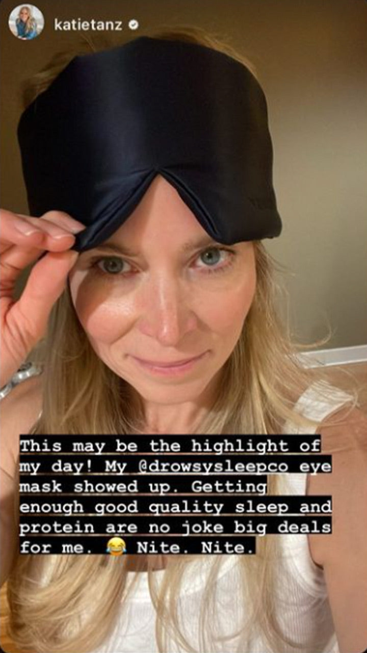 A woman with long blonde hair wears a black sleep mask pushed up on her forehead and smiles at the camera. Text overlay describes her excitement about receiving the eye mask for better sleep and protein.