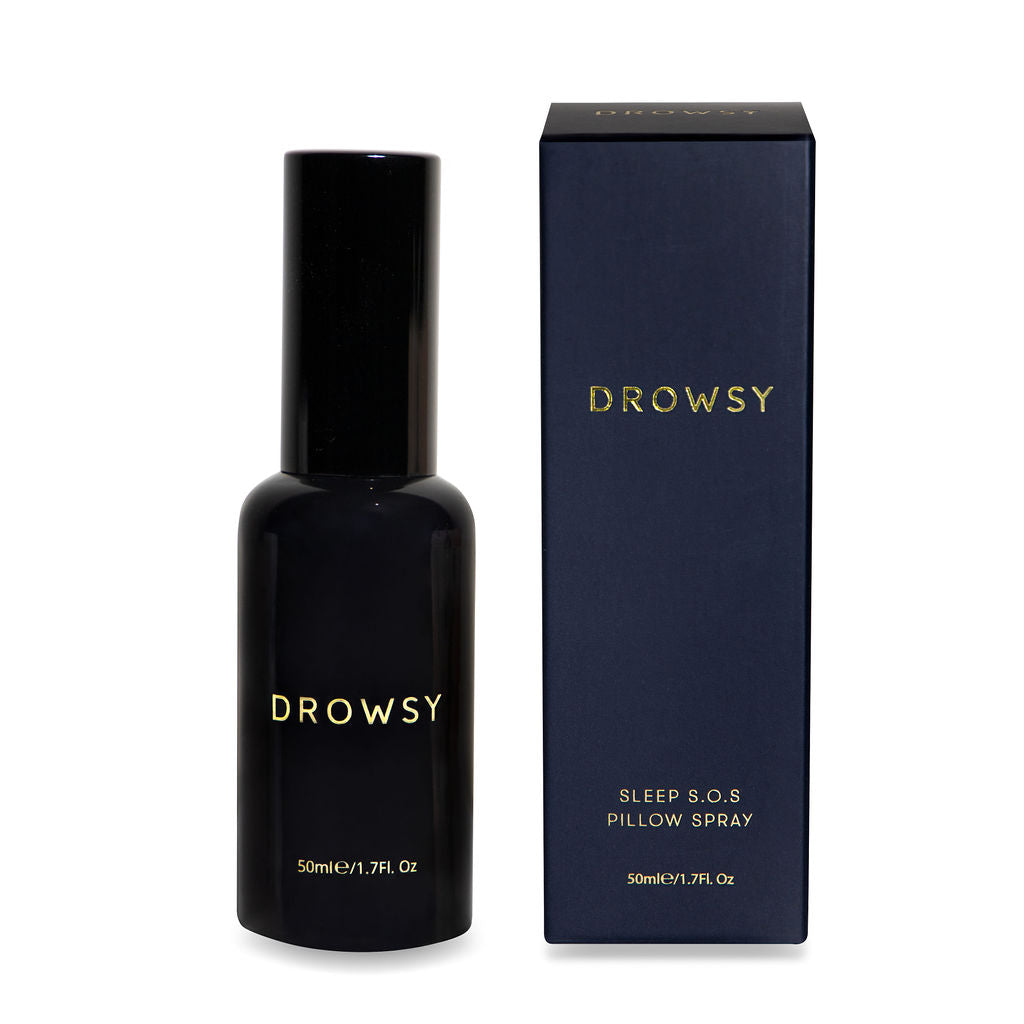 A dark bottle labeled drowsysleepco stands next to its box reading Drowsy Sleep S.O.S Pillow Spray, 50ml/1.7fl oz, beside a Midnight Blue Silk sleep mask and pillowcase from the Midnight ritual bundle Midnight Blue.