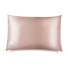 The Sunset Pink Silk Pillowcase by us.drowsysleepco features a smooth, light pink silk finish with a subtle sheen, designed for hair and skin benefits. The small us.drowsysleepco logo is embroidered in one corner on a white backdrop.