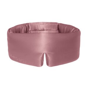 The Damask Rose eye mask by drowsysleepco is wide, silky pink with Drowsy embossed on the front, a central notch, and a soft padded blackout interior for enhanced comfort and rest.