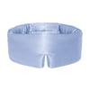 Model wearing Drowsy baby blue coloured silk sleep mask on a white background in the sunlight