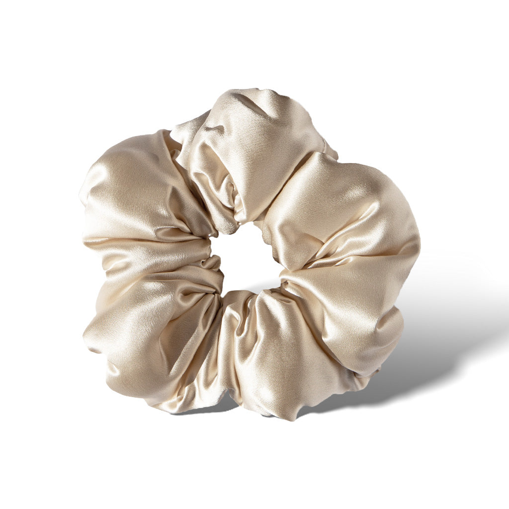 The Dusty Gold - Padded Scrunchie by us.drowsysleepco features a smooth, shiny finish in a circular shape—a chic and oversized hair accessory ideal for stylish sleep.