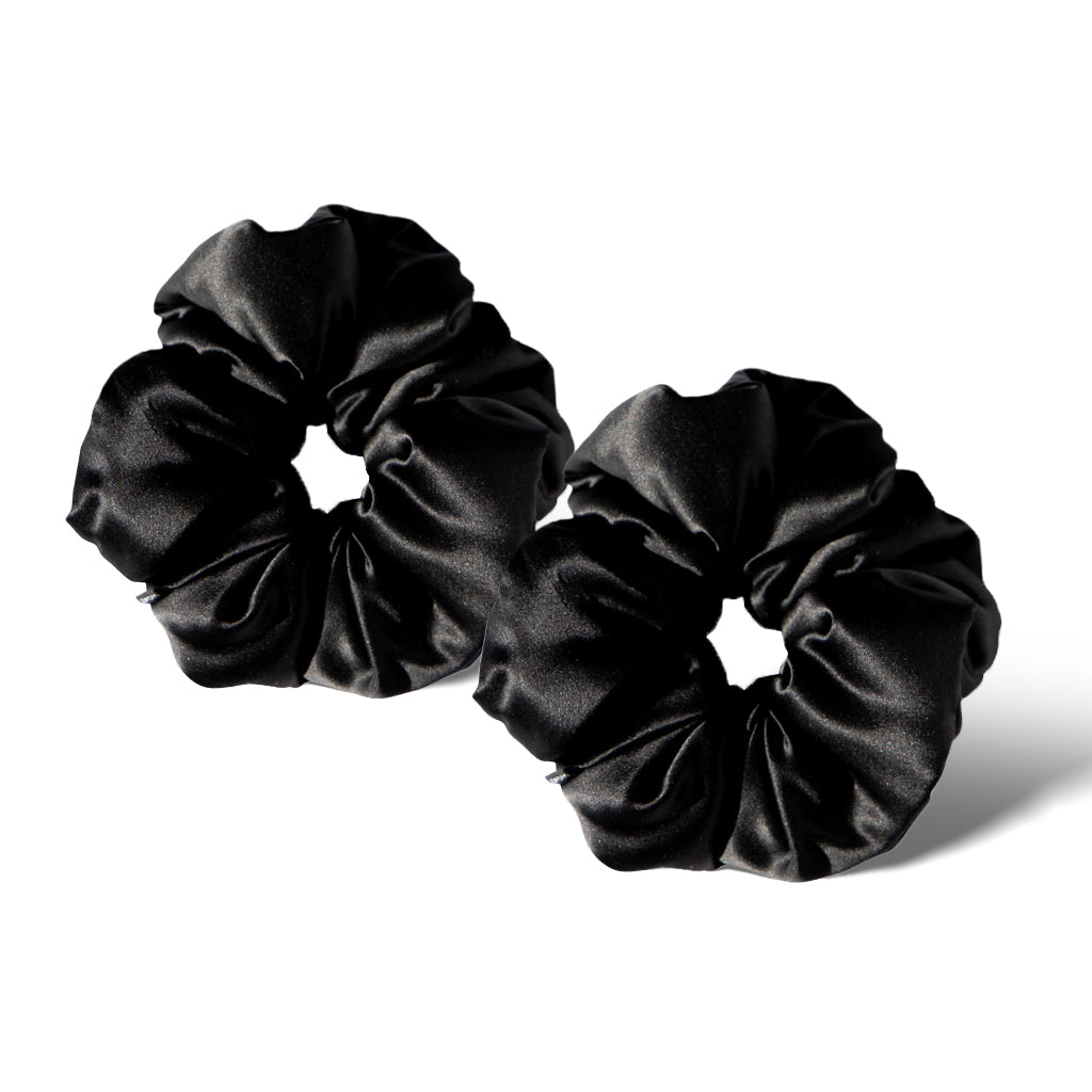 Two Black Jade - Padded Scrunchies by us.drowsysleepco are side by side on a white background, showcasing their smooth, shiny black satin fabric and plush, gathered circular shape.