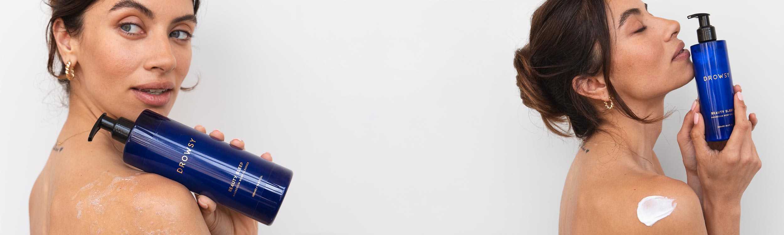 A woman with bare shoulders holds a large blue bottle of body cream labeled “Drowsy,” with lotion visible on her shoulder and back, against a plain white background.